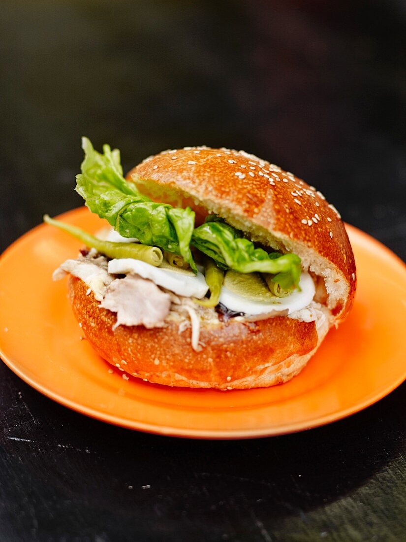 Sesame seed bun garnished with bonito escabeche