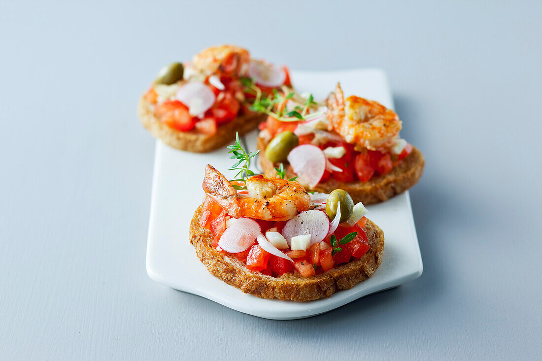 Vegetable and roasted gambas bruschettas