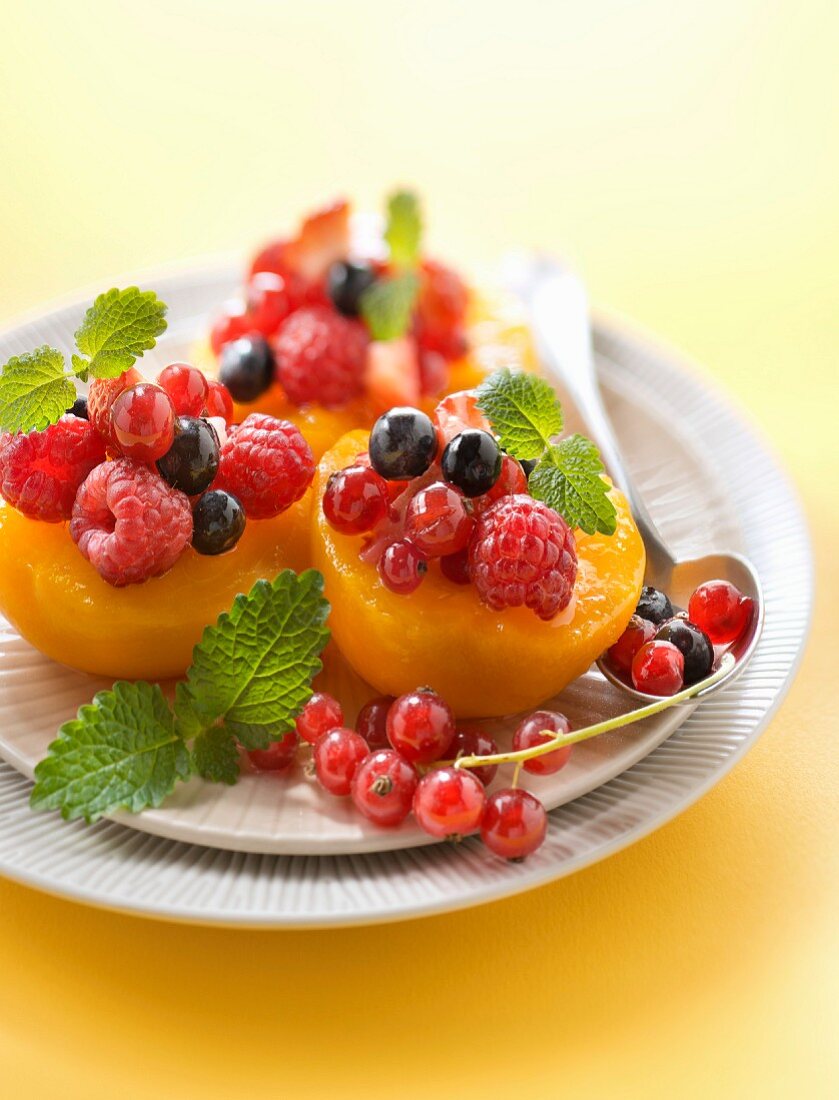 Peaches garnished with summer fruit