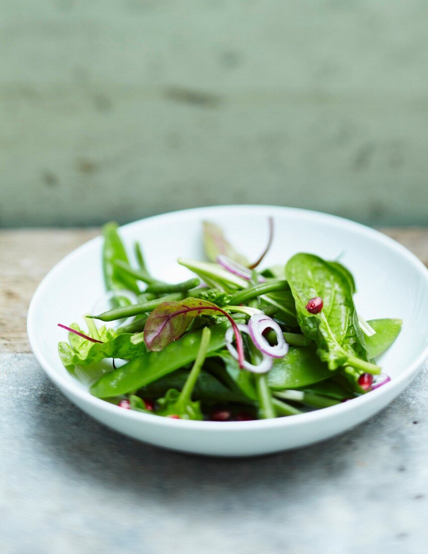 Mixed green vegetable and pomegranate seed salad