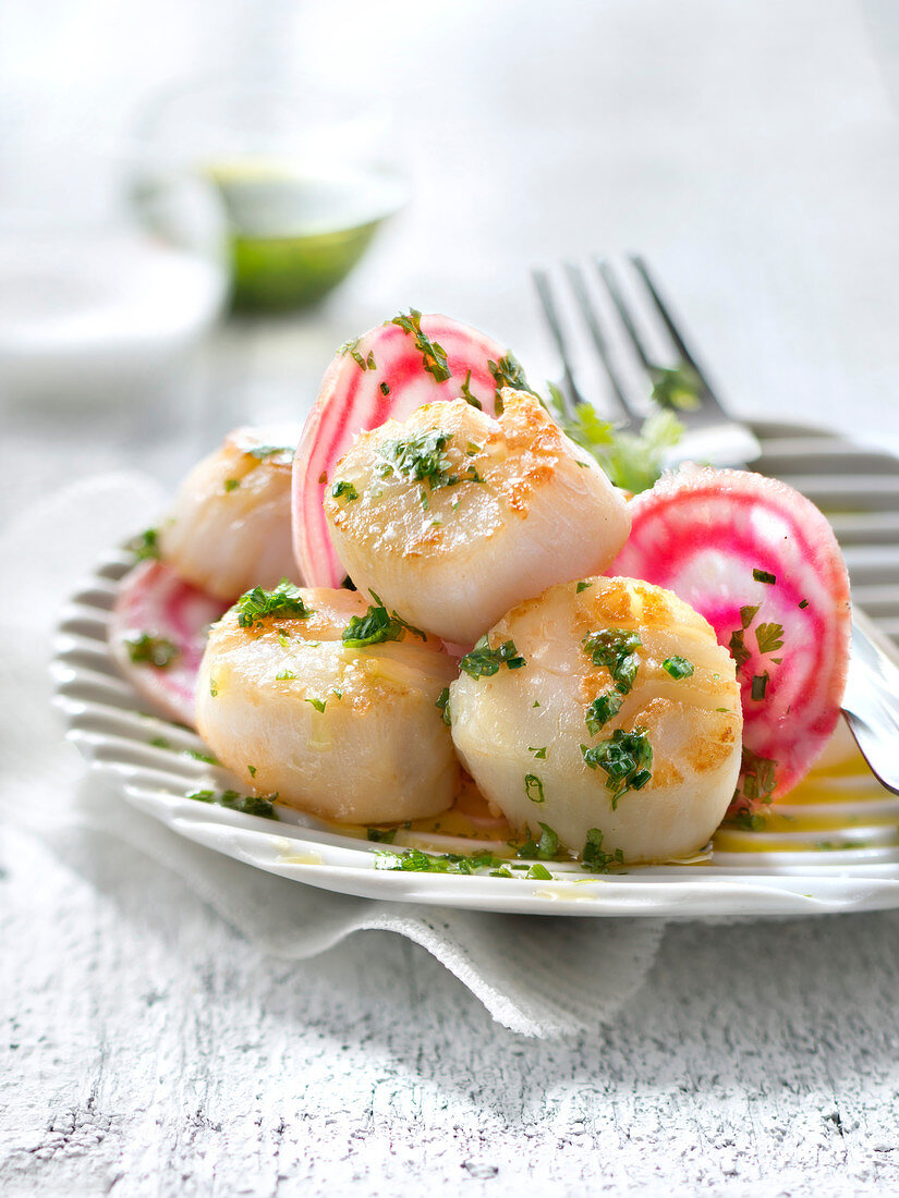 Scallops sauteed in salted butter and raw beetroot in herby vinaigrette