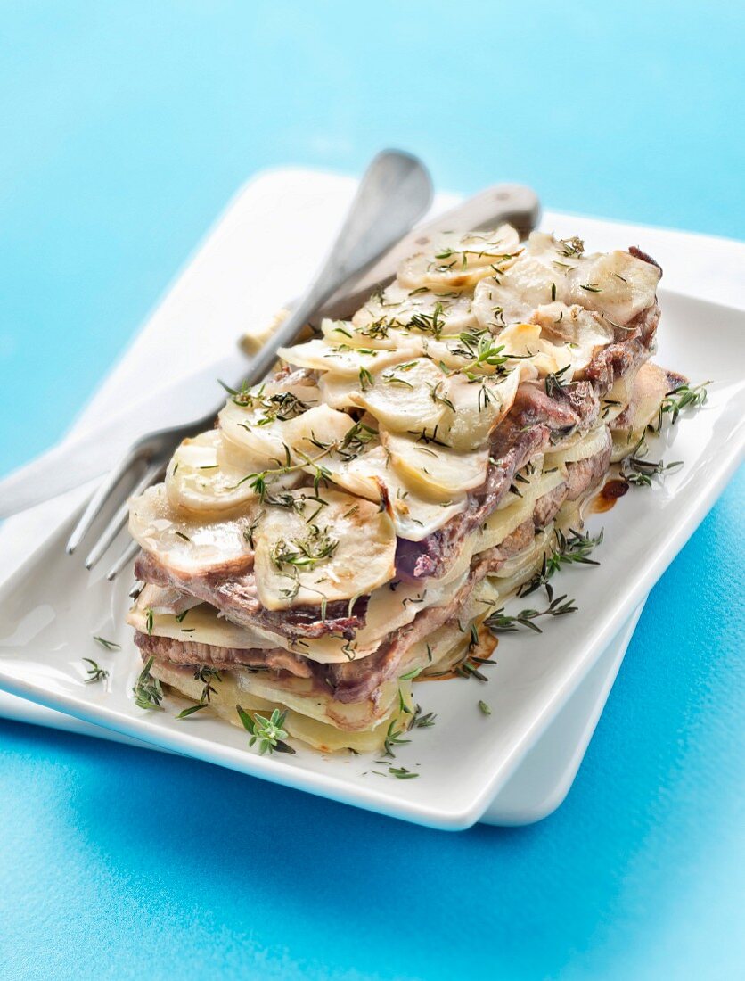 Thinly sliced potatonbeef and thyme layer