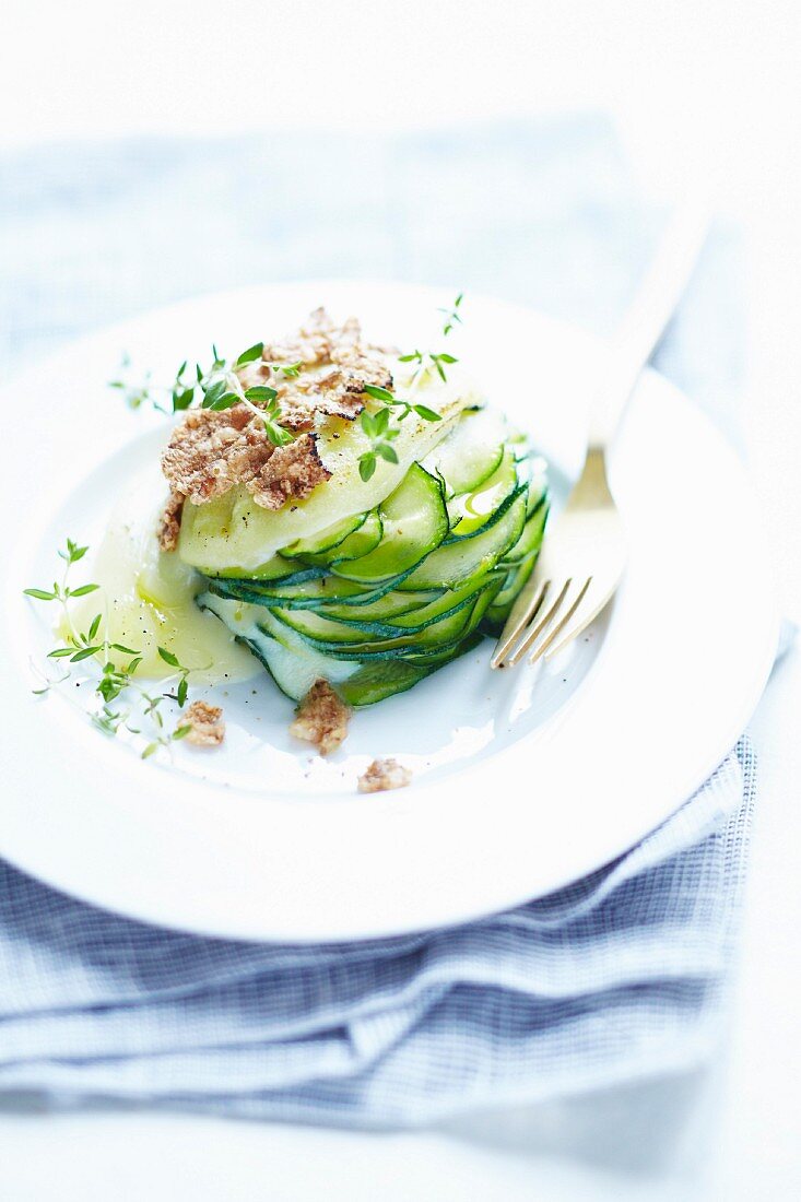 A cucumber millefeuille with grains