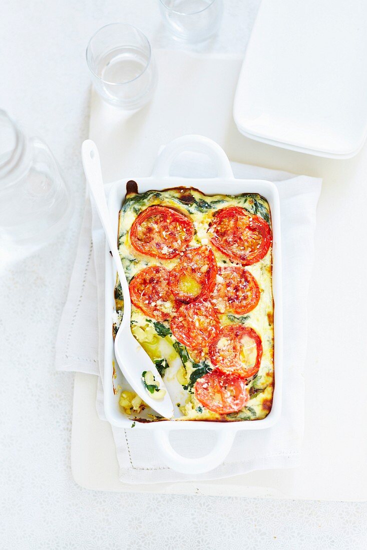 Clafoutis with spinach pasta and tomatoes