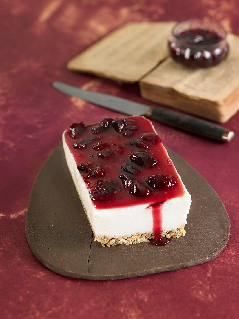 Cheesecake on a meusli base and coated with stewed cherries in syrup