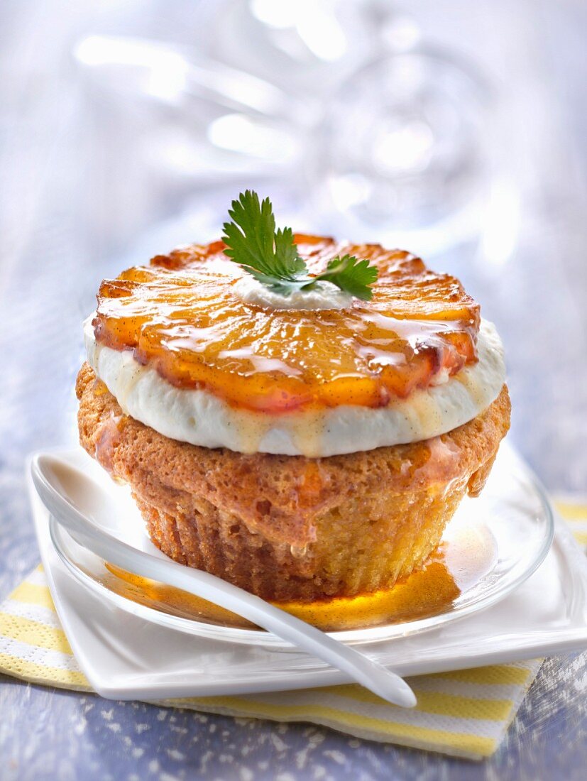 Financier topped with a caramelized pineapple slice and coriander