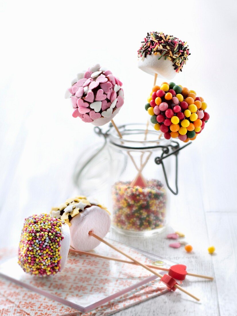 Chocolate coated marshmallows decorated with colored drops and vermicellis