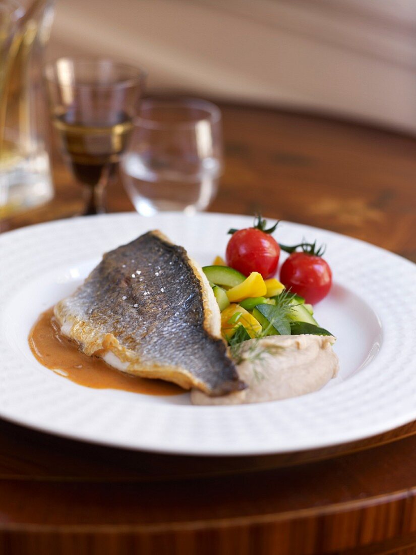 Sea bream with cherry tomatoes and yellow and green courgettes