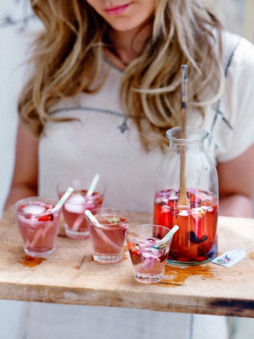 Woman serving a flowery cocktail