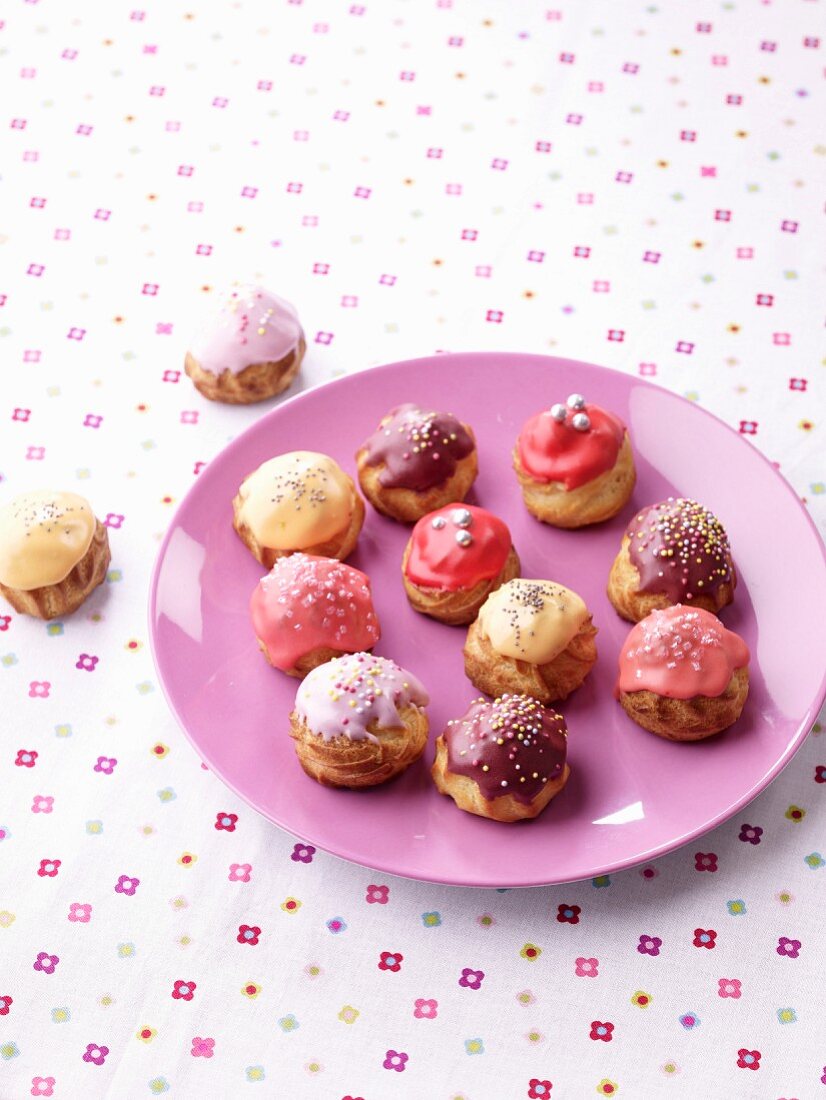 Lemon, raspberry, violet and blueberry cream puffs