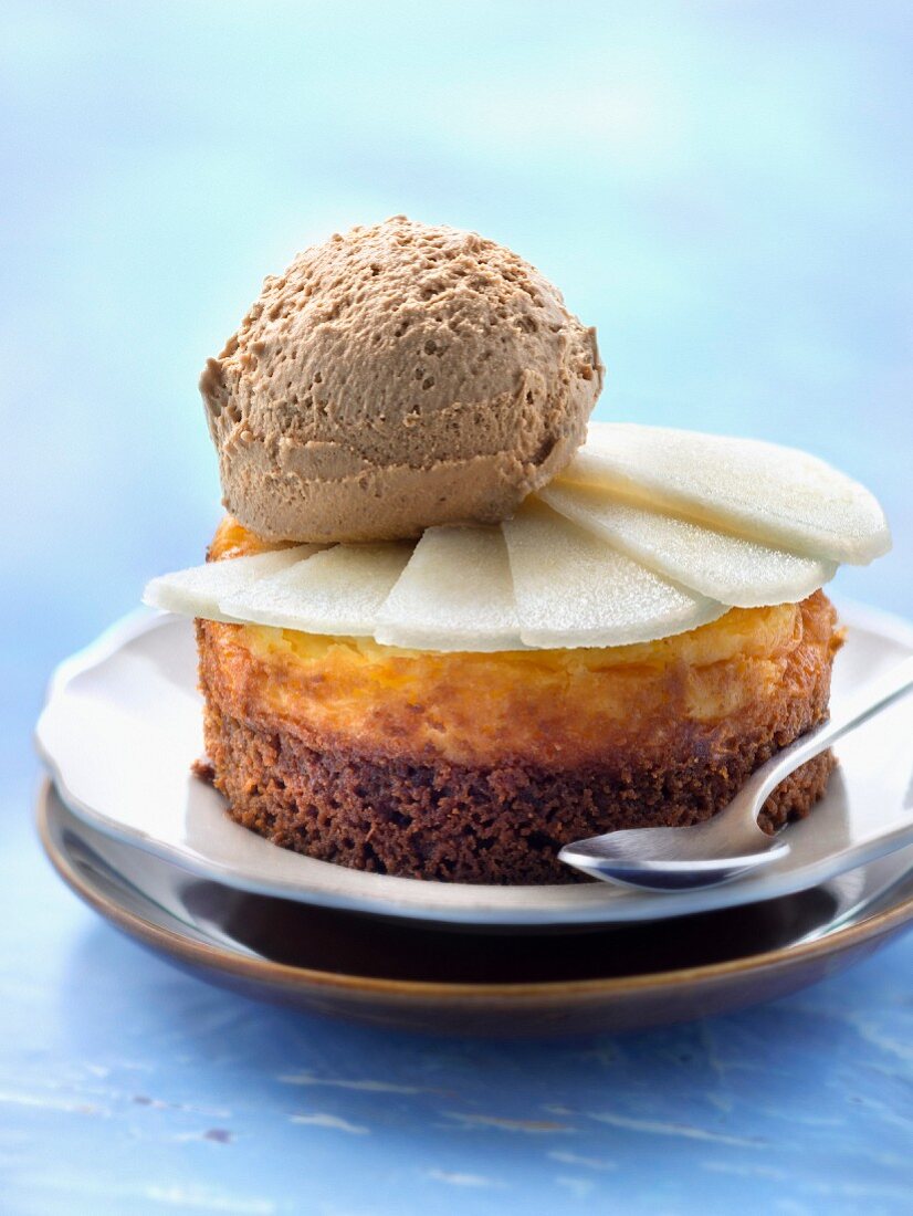 Small pear and speculos ginger biscuit cheesecake topped with a scoop of toffee ice cream