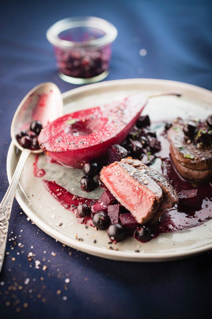 Doe tournedos,pear poached in red wine and beetroot-blackcurrant sauce
