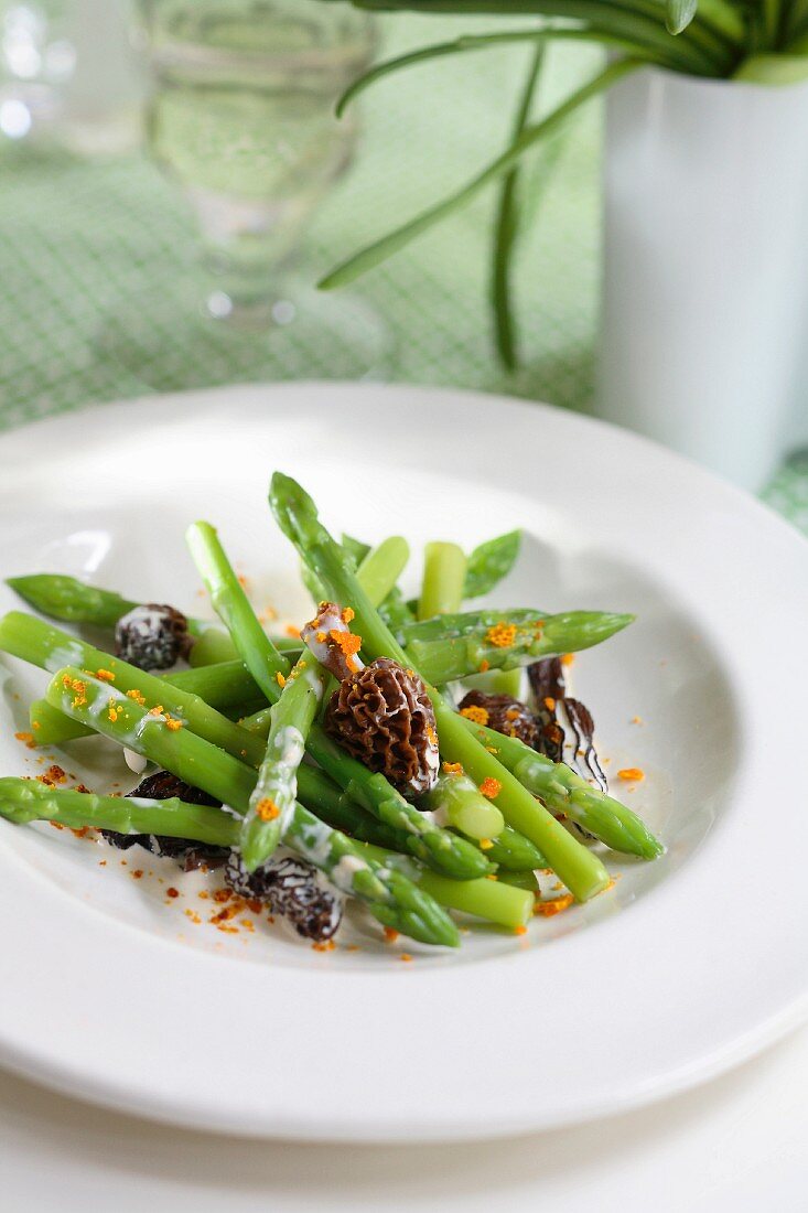 Green asparagus in creamy sauce with morels and finely chopped orange rinds
