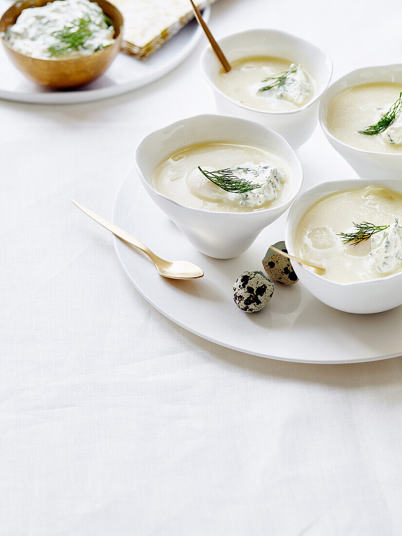 Cream of asparagus soup with cream cheese mousse, herbs and quail eggs
