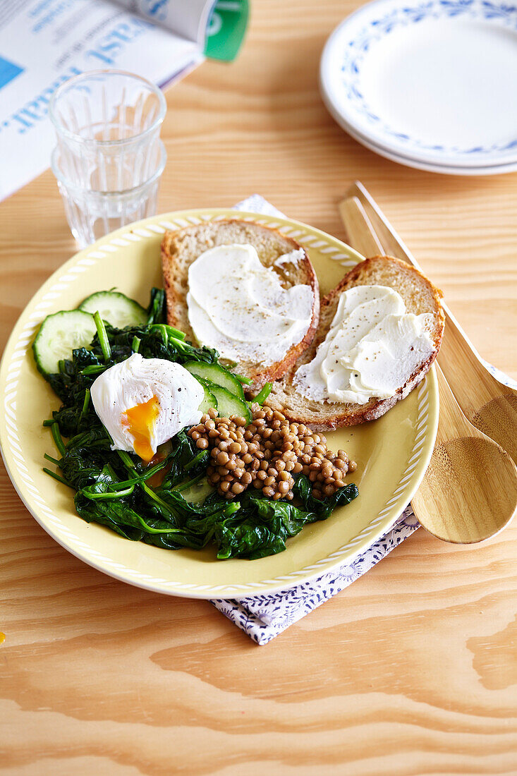 Plate of spinach, cucumber, lentils and poached egg, Philadelphia toast