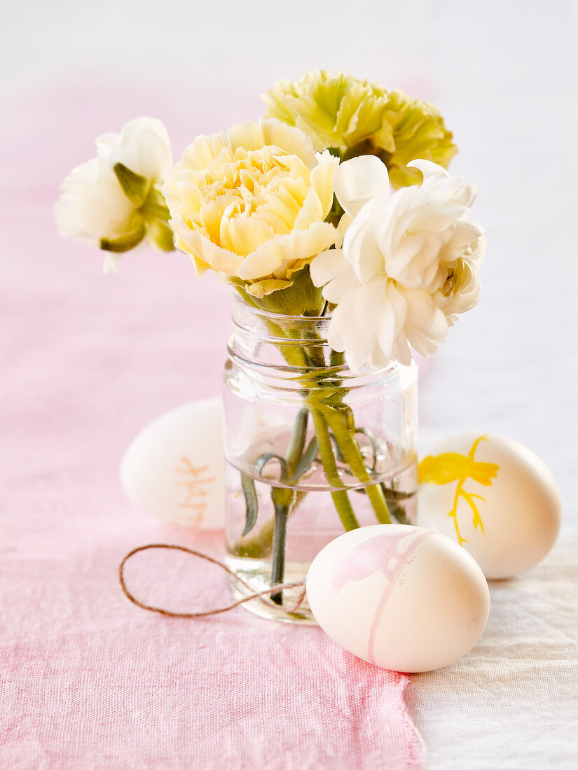 Bunch of flowers and decorated Easter eggs