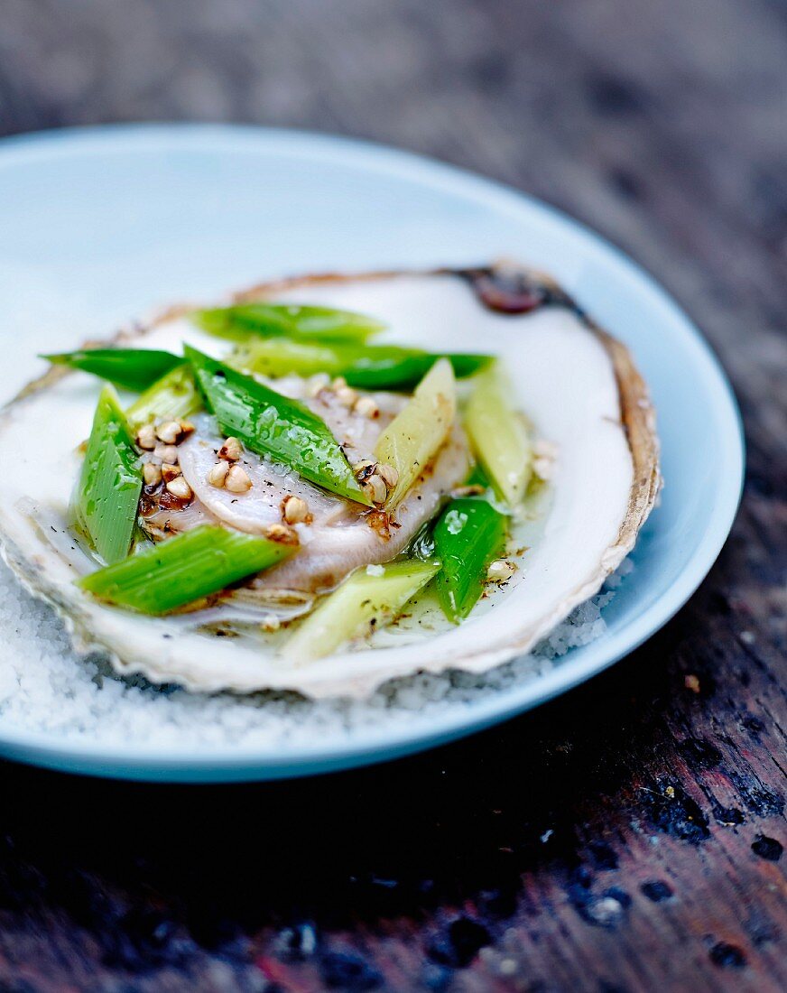 Flat oyster with hazelnut oil,sliced spring onion stalks and white pepper