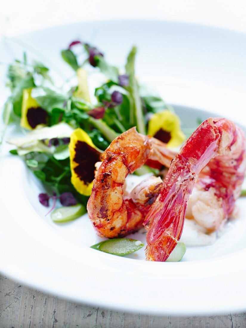 Marinated and roasted shrimps,sprout and pansy salad,lemon-flavored cream