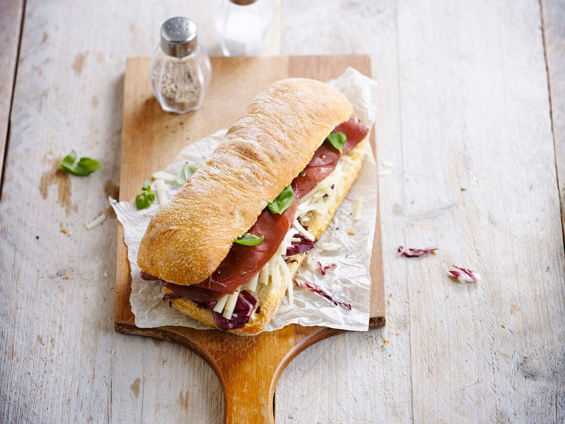Grisons meat,grated cheese and radicchio ciabatta bread sandwich