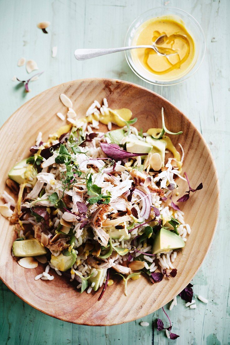 Rice,chicken,avocado,red onion and almond salad with mustard and honey sauce