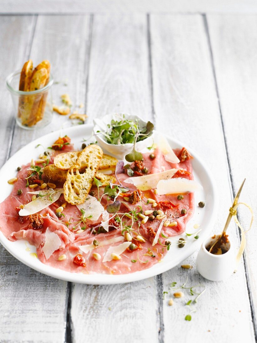 Beef carpaccio with Parmesan cheese and pine nuts
