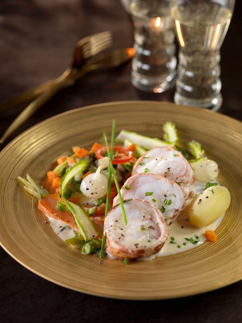 Roasted monkfish wrapped in bacon,pan-fried vegetables and potatoes