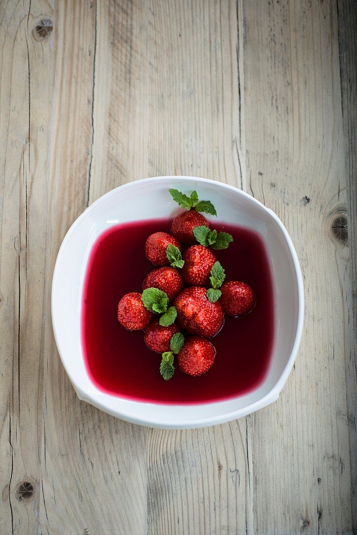 Strawberry soup with hibiscus flower syrup and mint