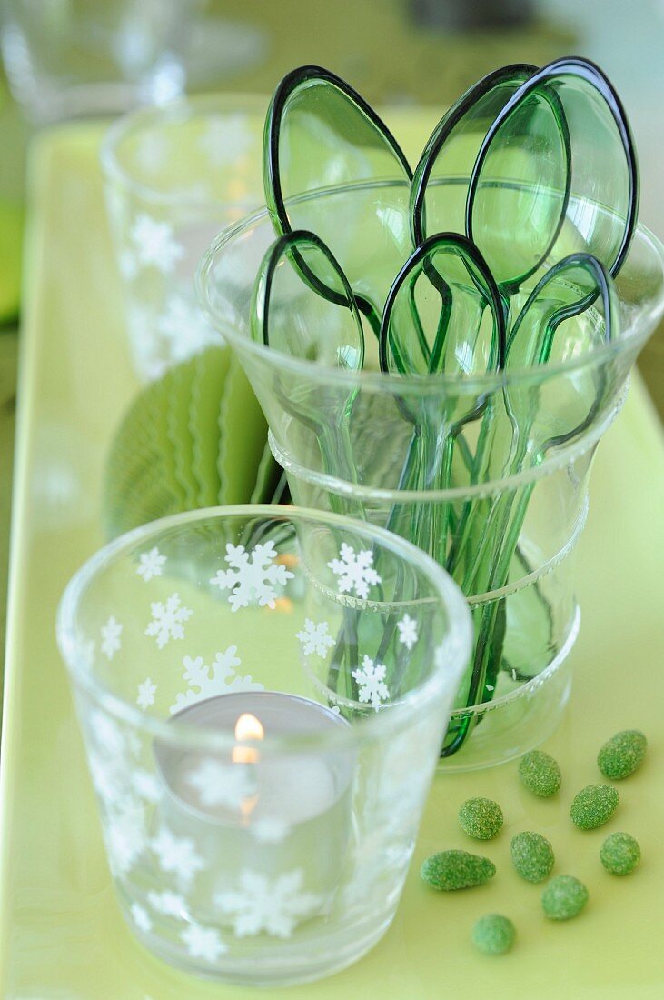 Green plastic cups and spoons