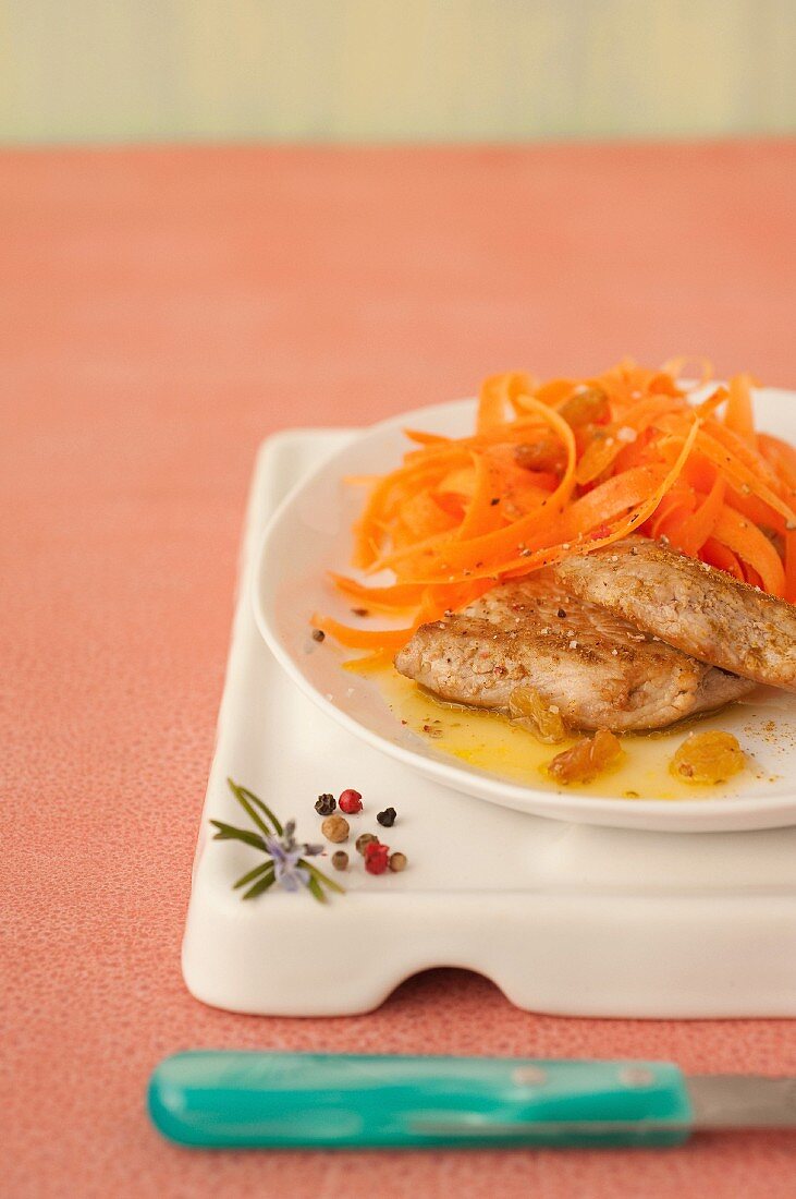 Curried veal escalope,carrot and raisin salad