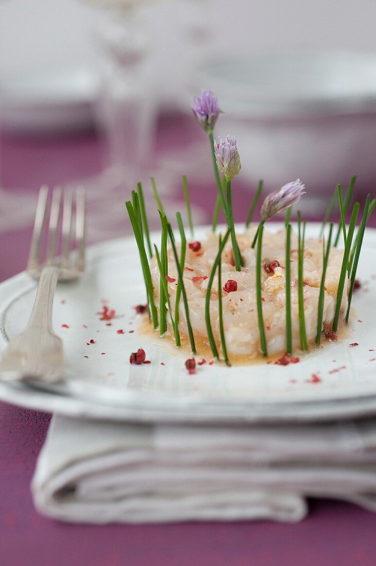 Langoustine and lychee tartare with pink peppercorns and chives