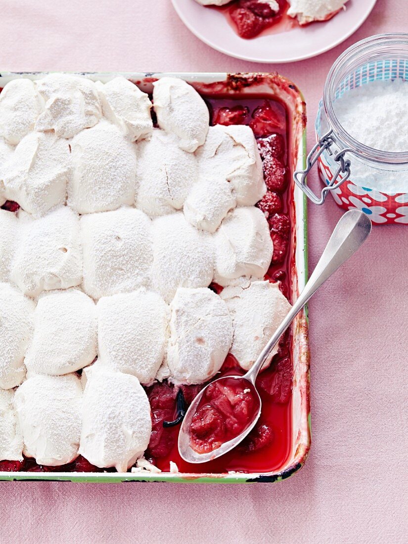 Geschmorte Erdbeeren mit Vanilleschote und Baiserhaube, mit Puderzucker bestreut