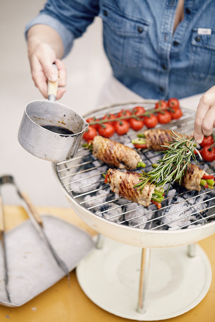 Stuffed Veal rolls with summer vegetables on the grill with a rosemary sauce drizzle