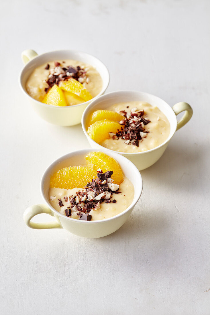 Orange cream dessert with dark chocolate flakes and hazelnuts