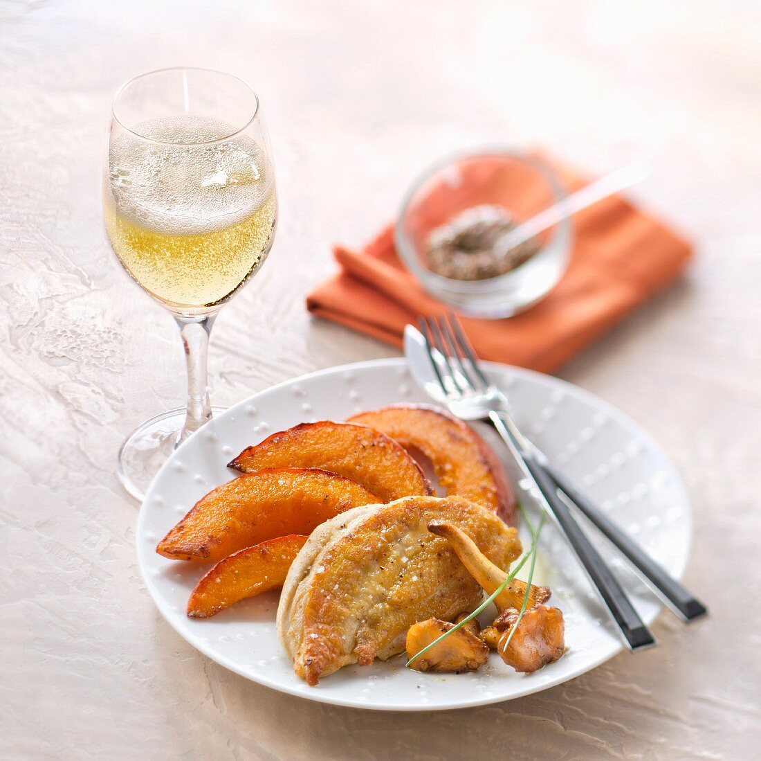 Roasted chicken breast with chanterelles and grilled pumpkin, glass of Crémant