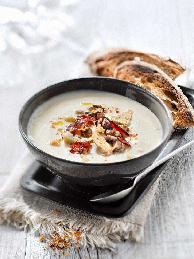 Cream of cauliflower soup with chorizo, foie gras and hazelnuts