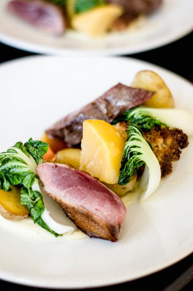 Duck with potatoes, chard and grilled cauliflower