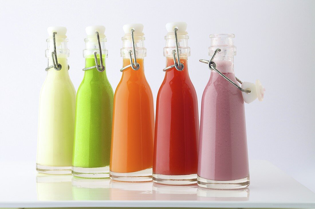 Different-flavored gazpachos in bottles