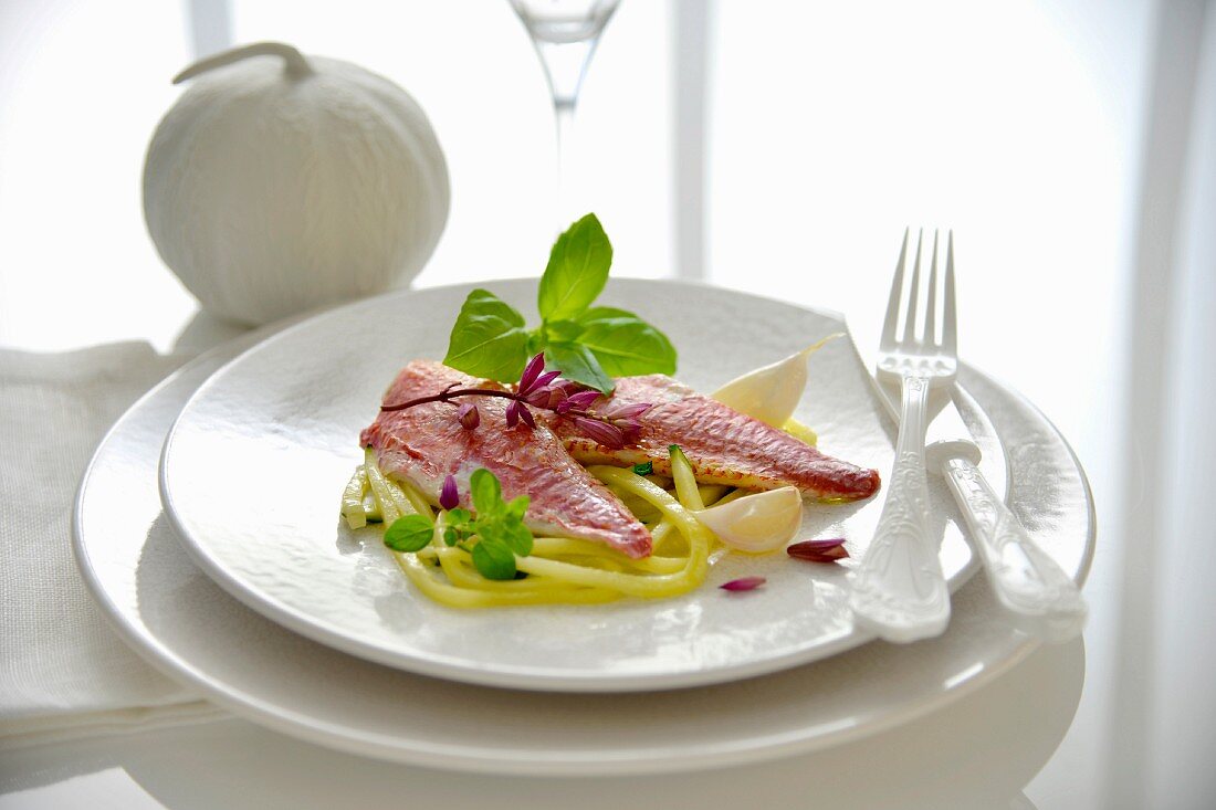 Red mullet fillets thin strips of courgettes with garlic