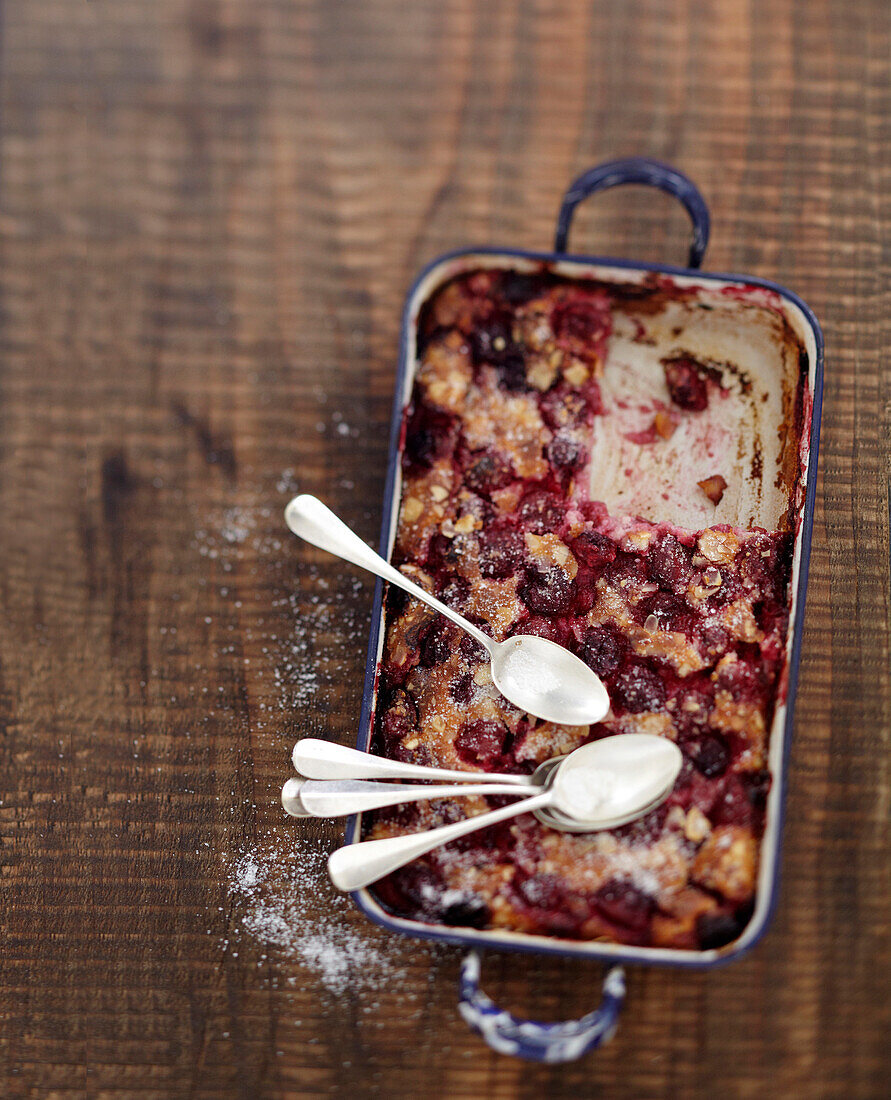 Cherry and thinly sliced almond batter pudding