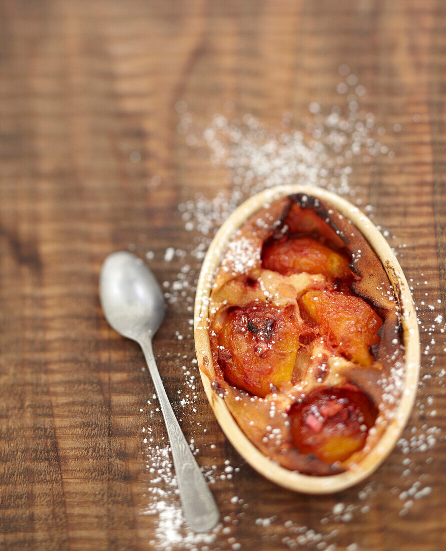 Roasted peach and pink praline batter pudding