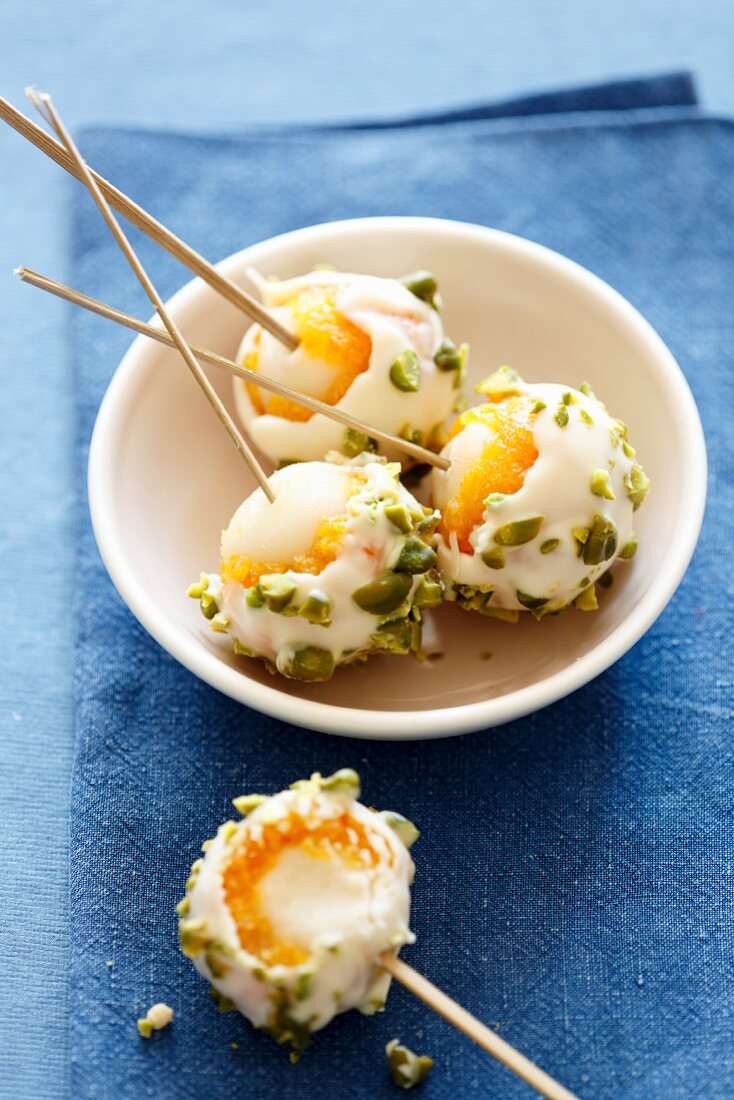 Lychees lollies with dried apricots, white chocolate and pistachios