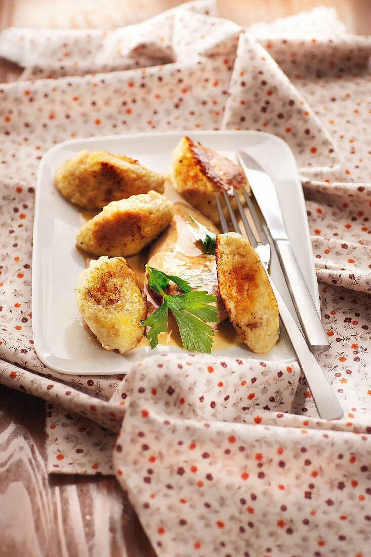 Sliced chicken breasts in creamy sauce,potato gnocchis