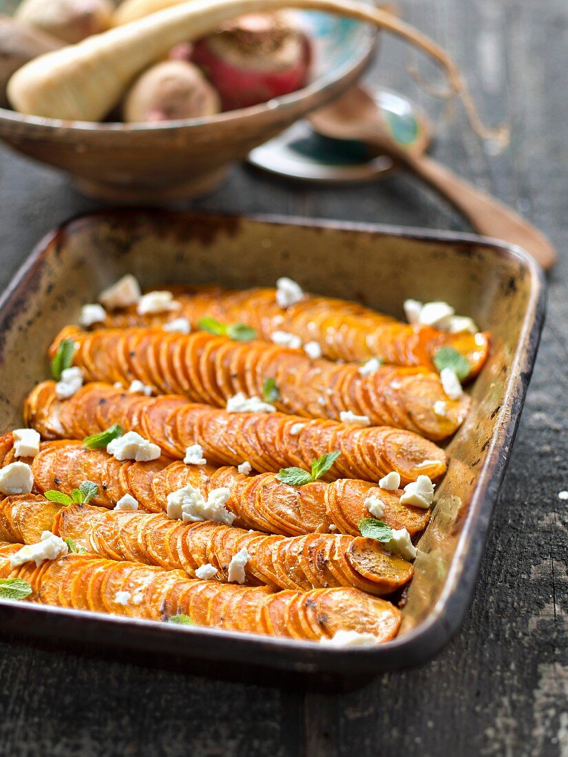 Sweet baked potatoes with feta and mint