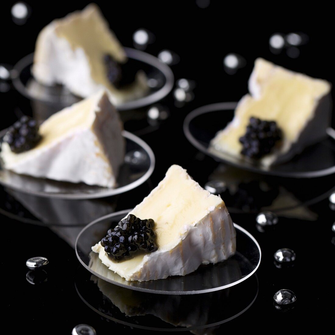 Four portions of Camembert with caviar