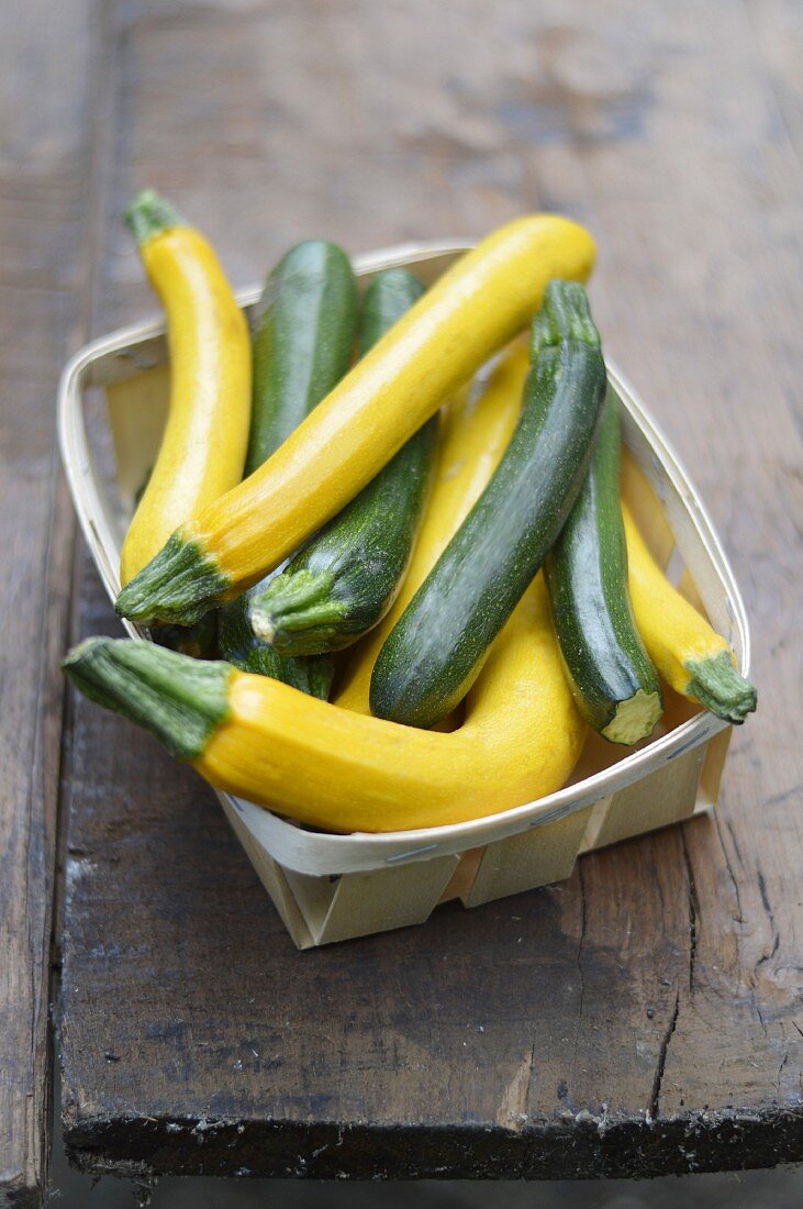 Punnet of yellow and green courgettes