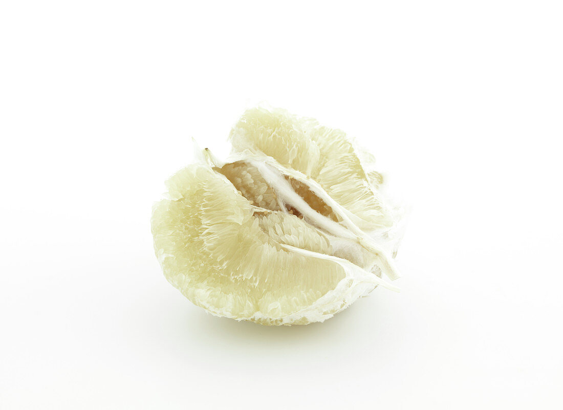 Quarter of a peeled grapefruit on a white background
