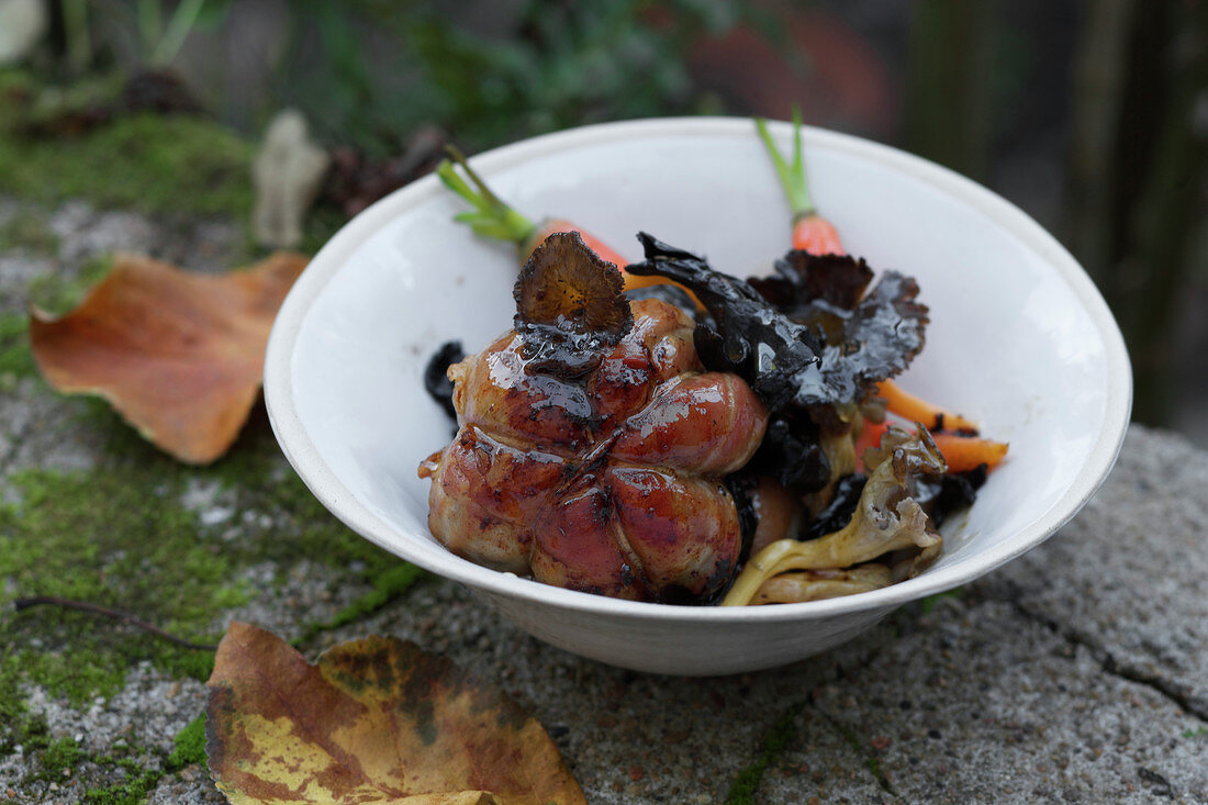 Veal Paupiette wrapped in bacon with wild mushrooms and carrots