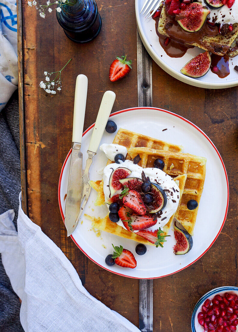 Waffles with whipped cream, fruit and chocolate shavings