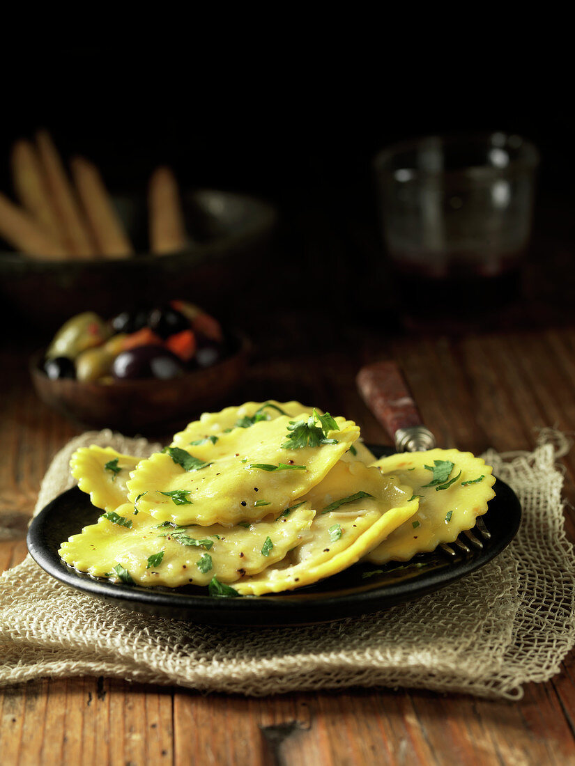 Plate of butternut squash ravioli with herb garnish