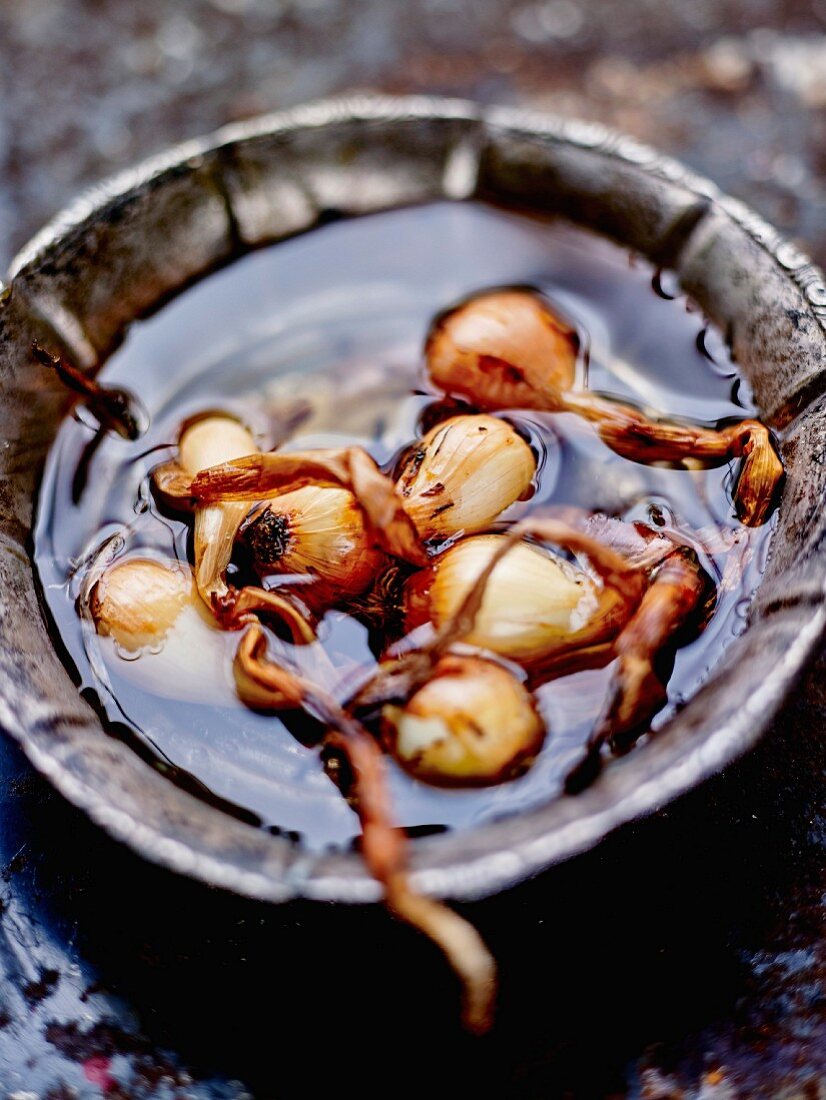 Soaking the small grelot onions in water to make it easier to peel them